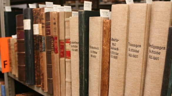 Alte hohe Bücher auf einem Regal