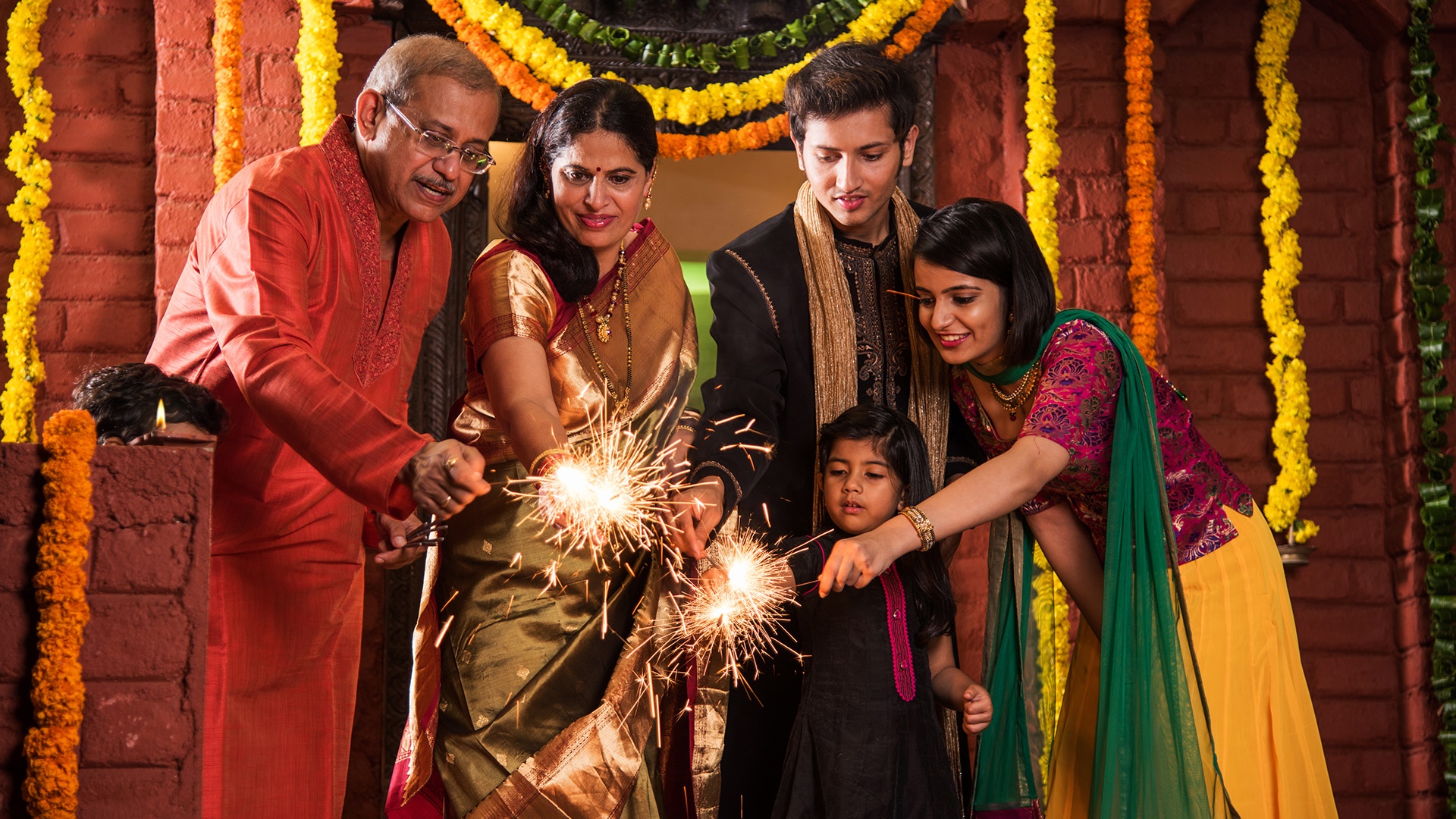 Indische Familie feiert Divali mit Wunderkerzen